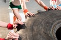 Adorable kids in sportswear training with tire at fitness studio Royalty Free Stock Photo