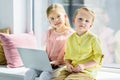 adorable kids using laptop and smiling at camera Royalty Free Stock Photo