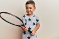 Adorable latin toddler smiling happy playing tennis using racket over isolated white background Royalty Free Stock Photo