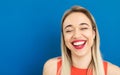 Adorable laughing blonde woman with wide red lips smile.