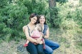 Adorable lesbian couple with their baby girl in nature.