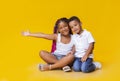 Adorable little african american siblings sitting on floor and cuddling Royalty Free Stock Photo