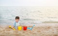 Adorable little Asian baby boy playing sand at beach Royalty Free Stock Photo