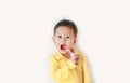 Adorable little Asian boy brushing teeth over white background Royalty Free Stock Photo