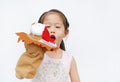 Adorable little Asian child girl hand wear and playing Lion puppets on white background. Educations concept