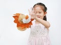 Adorable little Asian child girl hand wear and playing Lion puppets on white background. Educations concept