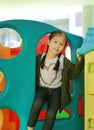 Adorable little Asian child girl playing toy playhouse at indoor playground Royalty Free Stock Photo