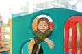 Adorable little Asian child girl playing toy playhouse at indoor playground Royalty Free Stock Photo