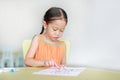 Adorable little Asian girl drawing and painting with water color on paper in children room Royalty Free Stock Photo