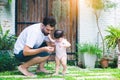 Adorable little baby daughter learning about environment at house her father teaching beloved daughter. Single dad embrace his Royalty Free Stock Photo