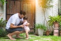 Adorable little baby daughter practice and learning walking that first time toddler girl walk on grass by father holding hands and