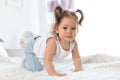 Adorable little baby girl crawling on bed Royalty Free Stock Photo