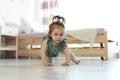 Adorable little baby girl crawling on floor Royalty Free Stock Photo