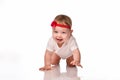 Little baby girl laughing, creeping playing in the studio, isolated on white background Royalty Free Stock Photo