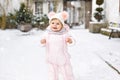 Adorable little baby girl making first steps outdoors in winter. Cute toddler learning walking Royalty Free Stock Photo