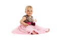 Adorable little baby girl in pink dress sitting on floor Royalty Free Stock Photo
