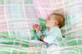 Adorable little baby girl sleeping in bed. Calm peaceful child dreaming during day sleep Royalty Free Stock Photo