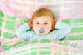 Adorable little baby girl sleeping in bed. Calm peaceful child dreaming during day sleep. Beautiful baby in parents bed Royalty Free Stock Photo