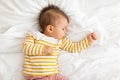 Adorable little baby girl sleeping on white bedding, feeling safe, watching sweet dreams, growing, top view, copy space Royalty Free Stock Photo