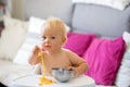 Sweet one years old baby boy, eating pasta at home, kid eats spaghetti Royalty Free Stock Photo