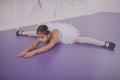 Charming young girl ballerina exercising at dance school