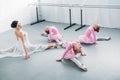 adorable little ballerinas and young teacher stretching and exercising together Royalty Free Stock Photo