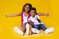 Adorable little black sister and brother showing thumbs up Royalty Free Stock Photo