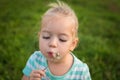 Adorable little blond girl with dandelion flower Royalty Free Stock Photo