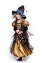 Adorable little blond girl wearing a witch costume smiling at the camera. Halloween. Fairy. Tale. Studio portrait isolated