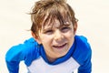 Adorable little blond kid boy having fun on tropical beach of Jamaica. Excited child playing and surfing in sun Royalty Free Stock Photo