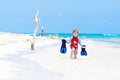 Adorable little blond kid boy having fun on tropical beach of Maldives. Excited child playing and surfing in sun Royalty Free Stock Photo