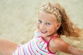 Adorable little blonde girl relax on sandy beach enjoy sea Royalty Free Stock Photo