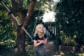 Smiling little girl hanging on a tree swing outside Royalty Free Stock Photo