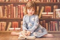 Adorable little bookworm girl reading books. Royalty Free Stock Photo