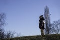 Adorable boy child runs around the hillside against the sky Royalty Free Stock Photo