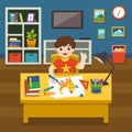 Adorable little Boy drawing the picture with colorful pencils. Boy doing school homework studying in living room.