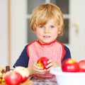 Adorable little boy helping and baking apple pie in home''s kitc Royalty Free Stock Photo