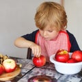 Adorable little boy helping and baking apple pie in home's kitchen Royalty Free Stock Photo