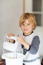 Adorable little boy helping and baking apple pie in home's kitchen Royalty Free Stock Photo