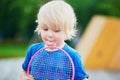 Little boy playing badminton with mom on the playground