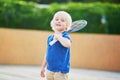 Little boy playing badminton on the playground