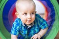 Adorable little boy playing inside a toy tunnel Royalty Free Stock Photo