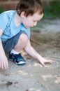 Adorable little boy playing in a sandbox Royalty Free Stock Photo