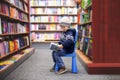 Adorable little boy, sitting in a book store Royalty Free Stock Photo