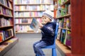 Adorable little boy, sitting in a book store Royalty Free Stock Photo