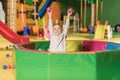adorable little boy smiling at camera while playing in pool with colorful Royalty Free Stock Photo