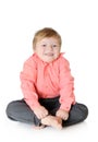 Adorable little boy smiling, sitting on the floor,
