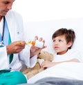 Adorable little boy taking cough medicine Royalty Free Stock Photo