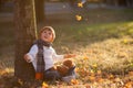 Adorable little boy with teddy bear in park on autumn day Royalty Free Stock Photo