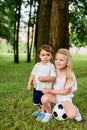 adorable little brother and sister with football ball embracing Royalty Free Stock Photo